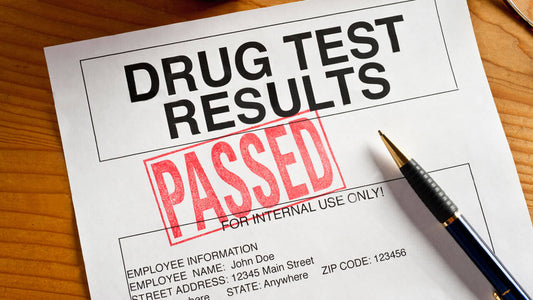 A Document On The Brown Table Claiming That An Employee Passed A Drug Test For A New Job