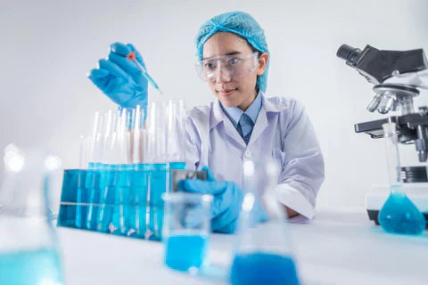 A female researcher in lab gear sampling in testing tubes delta-8 for analysis 