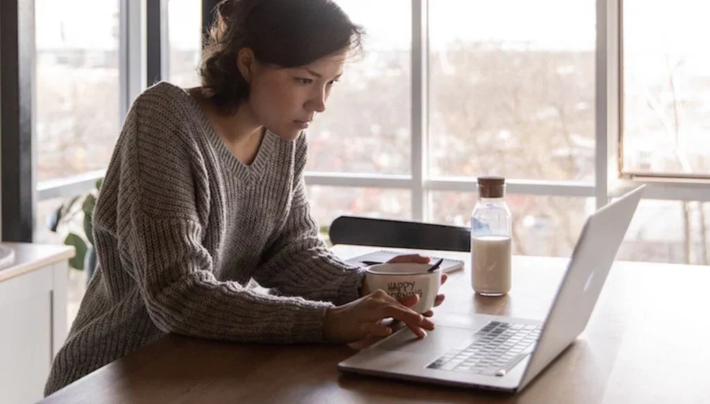 Girl Sitting With Her Laptop Reading About Urine Drug Tests