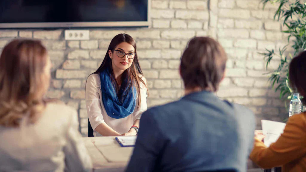 A hiring Manager Sitting With Potential Employees Talking About Pre-Employment Drug Testing