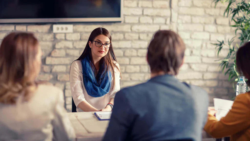 A hiring Manager Sitting With Potential Employees Talking About Pre-Employment Drug Testing