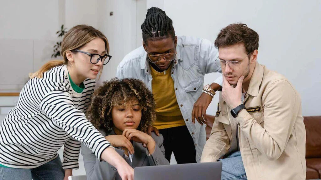 A diverse group of young people reading about multi-panel and single-panel tests on the laptop