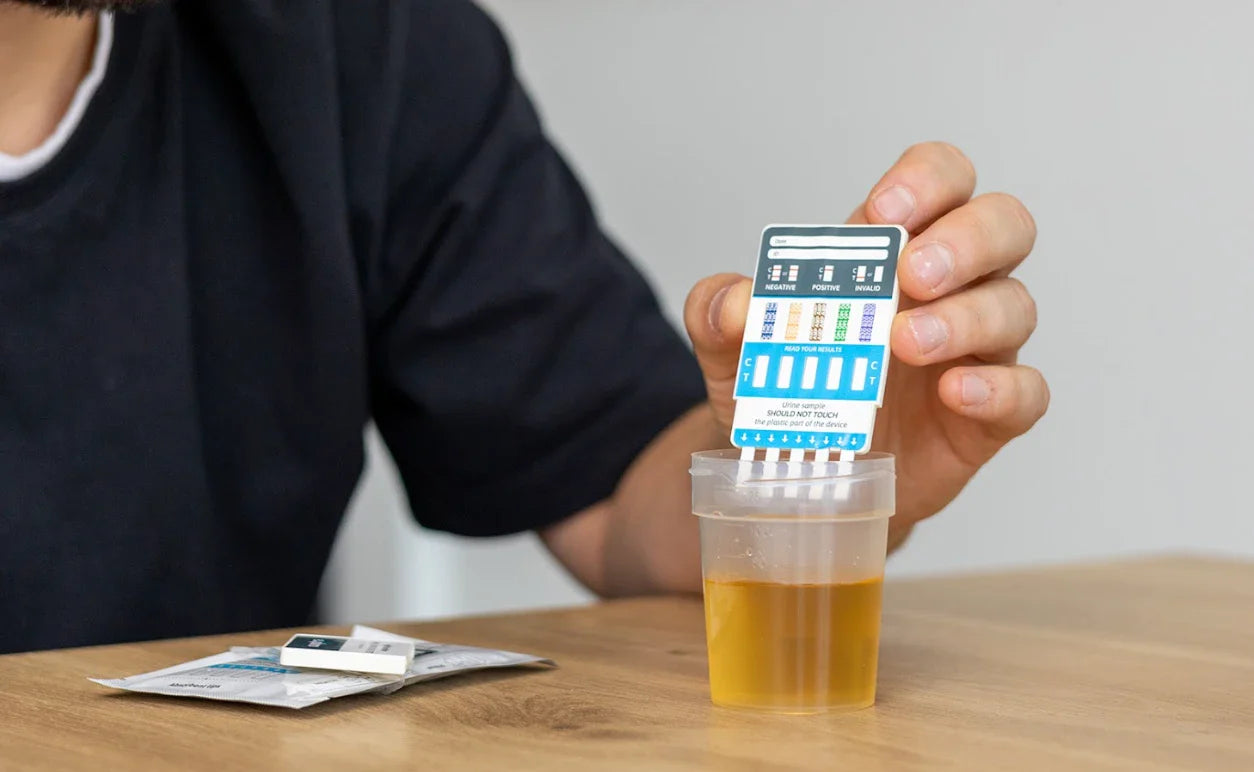 A man testing his urine sample with an exploro at home drug test 