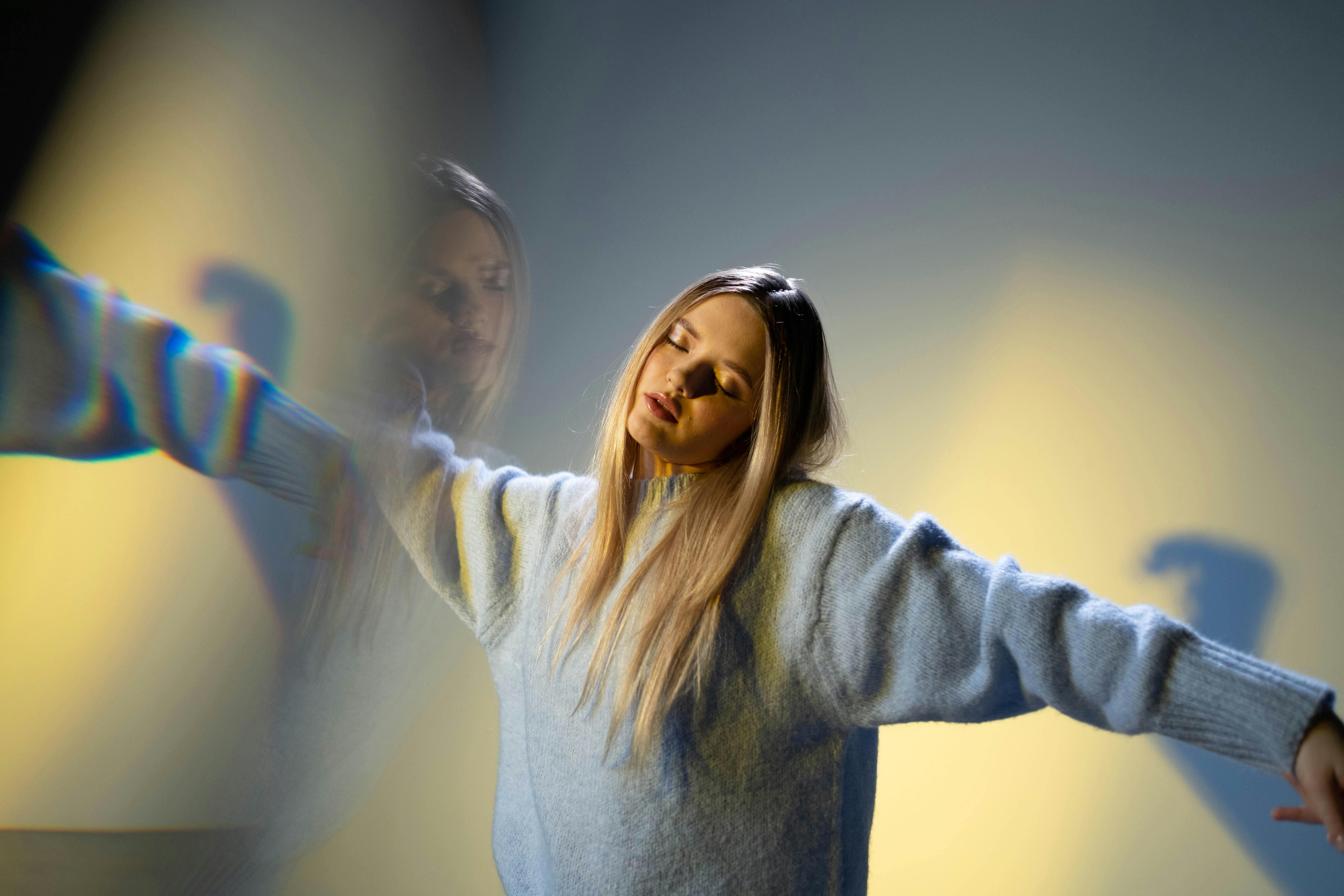 Young woman dancing in a dreamlike state, visual distortion representing party drug effects